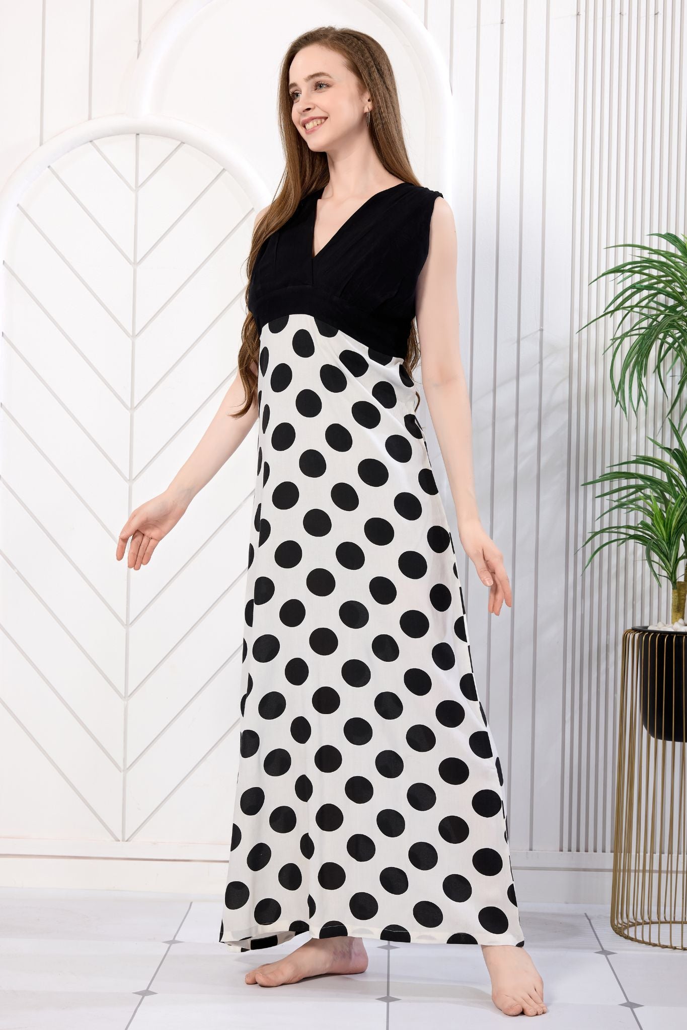 Woman in black and white polka dot maxi gown walking pose - Gemini Nightwears